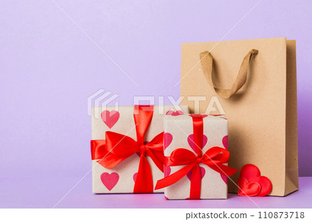 Shopping bag with gift box on colored background perspecrive view. Space for text holiday concept 110873718
