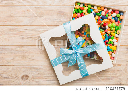 Box with sweet chocolate candies on color background, Various candy sweets. Valentines day gift box. Top view flat lay with copy space 110873779