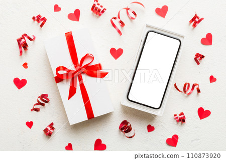 Opened gift box with ribbon and phone on color background, top view. Blank open box packaging mockup , Template for your design - branding mockup 110873920