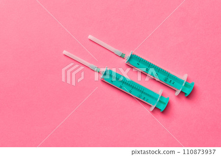 Top view of medical syringes on colorful background with copy space. Injection equipment concept 110873937