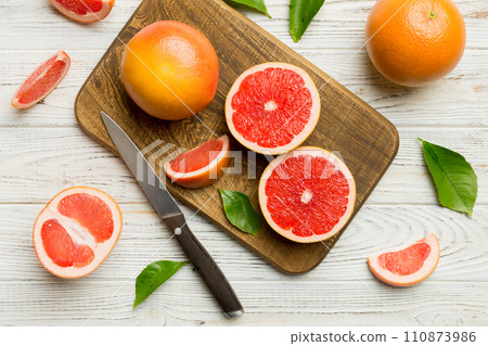fresh Fruit grapefruit slices on colored background. Top view. Copy Space. creative summer concept. Half of citrus in minimal flat lay with copy space 110873986