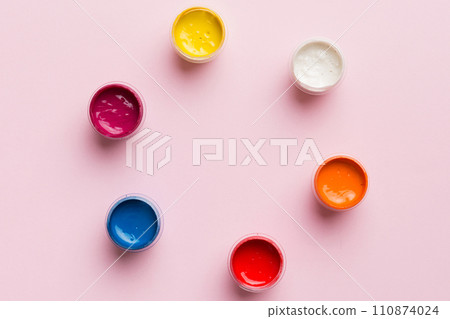 jars with gouache of different colors on Colored background. hobby painting. Top view with empty space. workplace for creativity. home teaching concept drawing jars with gouache of different colors on Colored background. hobby painting. Top view with empty space. workplace for creativity. home teaching concept drawing 110874024