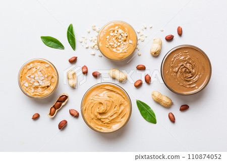Glass jar with peanut butter on table background, top view space for text and close up Glass jar with peanut butter on table background, top view space for text and close up 110874052