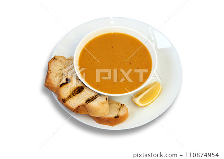 Tasty lentil bowl on plate with lemon and bread isolated on white 110874954
