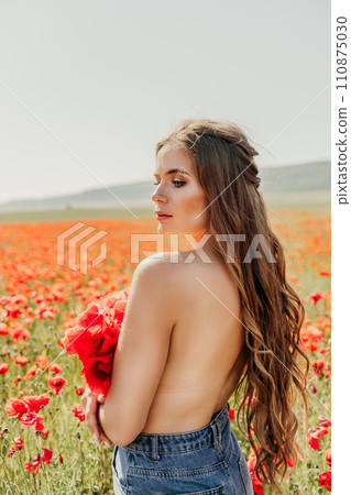 Woman poppies field. portrait happy woman with long hair in a poppy field and enjoying the beauty of nature in a warm summer day. 110875030
