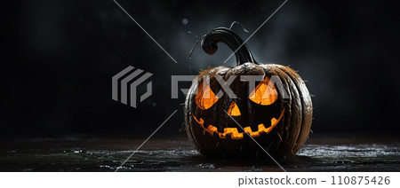 Carved out glowing orange halloween pumpkin jack o lantern on black background with copy space AI generated 110875426