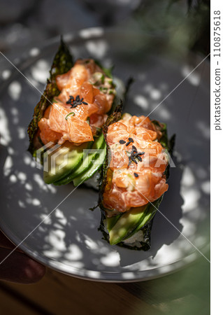 Portion of trendy sushi hand rolls with salmon 110875618