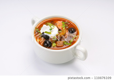 Traditional Russian soup solyanka in a white bowl on a white background Traditional Russian soup solyanka in a white bowl on a white background 110876109
