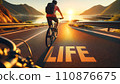 Cyclist on Sunrise Coastal Road with Life Inscription 110876675