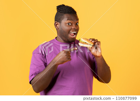Portrait Of Funny Hungry Black Guy Pointing At Burger 110877099