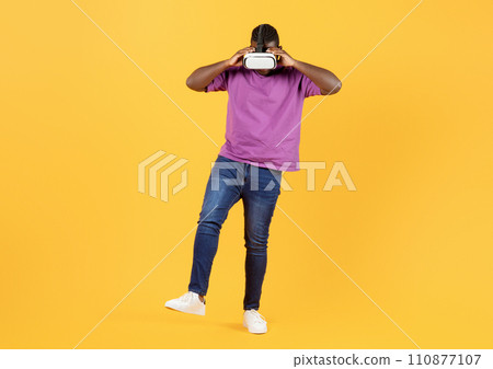 Full Length Of African Guy In Casual Wearing VR Goggles 110877107