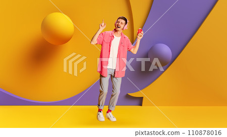 Music streaming service ads. Social media campaigns for music festivals or concerts. Young positive man listening to music in headphones 110878016