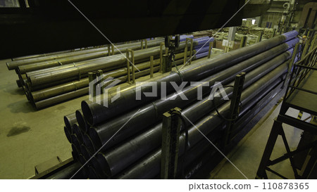 Yellow Indoor Crane. Work hanging of a crane at the plant for the production of pipes 110878365