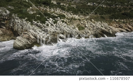 The waves breaking on a stony beach, forming a spray. Footage. Splashing waves on the rocks of the sea The waves breaking on a stony beach, forming a spray. Footage. Splashing waves on the rocks of the sea 110878507
