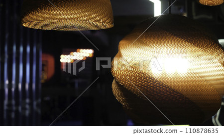 Warm lighting coming out from beautiful lamps while taking a hot cup of coffee in a trendy cafe with nice environment Warm lighting coming out from beautiful lamps while taking a hot cup of coffee in a trendy cafe with nice environment 110878635