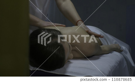 Masseur doing massage on woman body in the spa salon. Beauty treatment concept Masseur doing massage on woman body in the spa salon. Beauty treatment concept 110878685