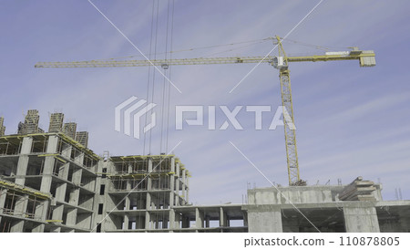 Apartments construction site with crane. Crane and building construction Apartments construction site with crane. Crane and building construction 110878805