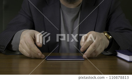 Teacher sits at the table with the record book Teacher sits at the table with the record book 110878813