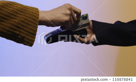 Close up of customer paying by credit card. Stock. Payment for purchase by Bank transfer on a colored background Close up of customer paying by credit card. Stock. Payment for purchase by Bank transfer on a colored background 110878841