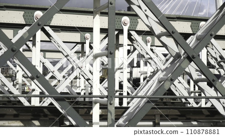 Close-up view of the white wagon going rapidly on the bridge against the blue sky. Action. Urban rail transport 110878881