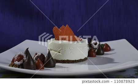 Cake with meringue frosting and raspberries. Meringues Pavlova cakes with fresh raspberry and blueberry on a dark blue background. Big meringue zephyr on plate Cake with meringue frosting and raspberries. Meringues Pavlova cakes with fresh raspberry and blueberry on a dark blue background. Big meringue zephyr on plate 110878925