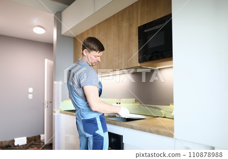 Man electrical repairs kitchen surface apartment Man electrical repairs kitchen surface apartment 110878988