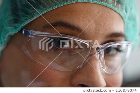 Pleased look female doctor in safety glasses Pleased look female doctor in safety glasses 110879074