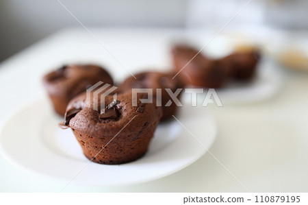 Close up, on white plate are chocolate muffins 110879195