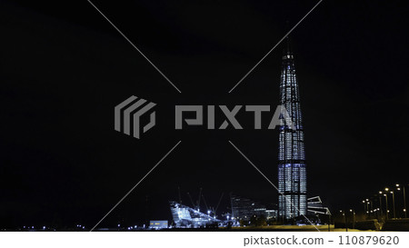 View from the bottom on the beautiful skyscraper Lahta center at night designed by award winning British Architect Tony Kettle. Concept. The Europe's highest tower View from the bottom on the beautiful skyscraper Lahta center at night designed by award winning British Architect Tony Kettle. Concept. The Europe's highest tower 110879620