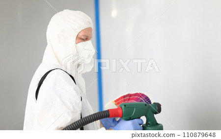 Builder in uniform chooses color for painting wall 110879648