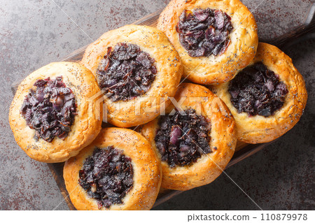 Cebularz Lubelski is a round-shaped Polish Onion poppy flatbread close-up on a wooden board. Horizontal top view 110879978