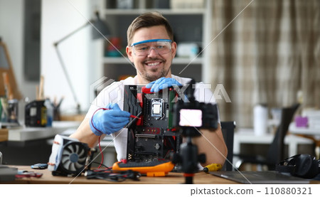 Man removes computer repair on camcorder for blog 110880321