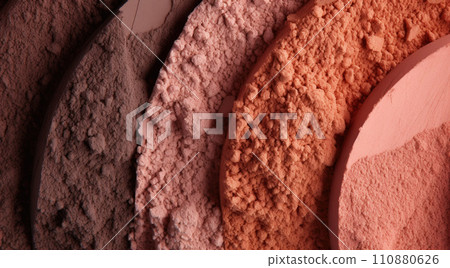Cosmetic set of various shades compact and loose face powder, bronzed pearls, concealer and makeup brush on black background. Top view point, flat lay 110880626