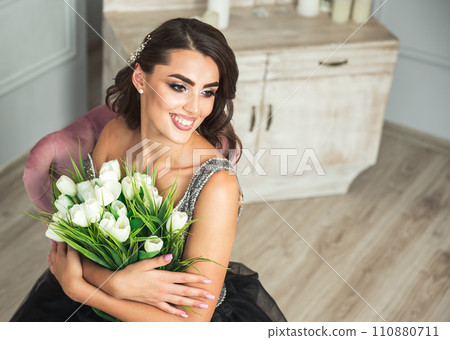Amazing luxury seductive woman in stylish black dress posing in studio 110880711