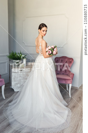 Attractive young smiling bride in wedding dress. Fashion model, beauty 110880715