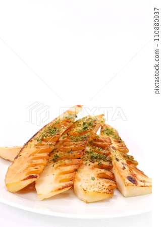 Grilled bamboo shoots, soy sauce flavor, bright background, white plate Grilled bamboo shoots, soy sauce flavor, bright background, white plate 110880937