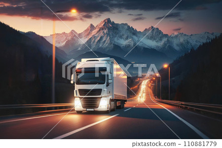 Long Haul Semi-Truck with Cargo Trailer Full of Goods Travels At Night on the Freeway Road 110881779
