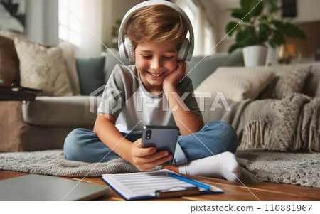 Happy smile Preteen boy kid using a smartphone and headphones for online learning, app social media, or playing a game 110881967