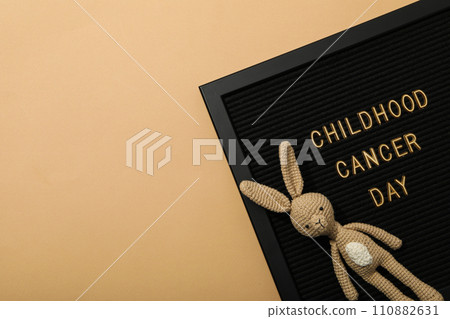 A black board with the inscription Childhood Cancer Day and with a rabbit A black board with the inscription Childhood Cancer Day and with a rabbit 110882631