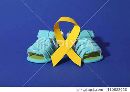 Blue children's shoes with a yellow ribbon Blue children's shoes with a yellow ribbon 110882638