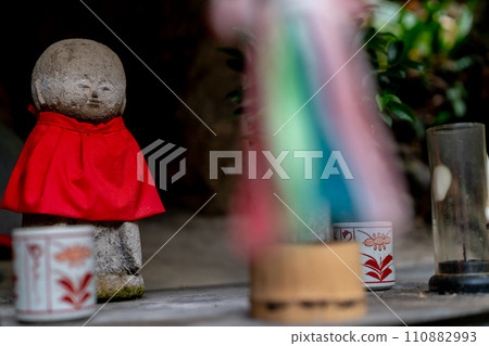 A cute Jizo statue that is loved by the common people and watches over the area. 110882993