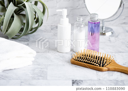 White towel, brush, mirror, and 3 types of cosmetic bottles 110883090