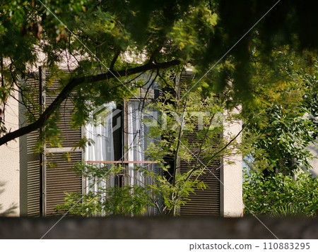 Balcony of an Italian style house in a modern house. Sunny day in a green garden 110883295