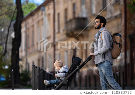 Young hindu man having a walk with kid Young hindu man having a walk with kid 110883752
