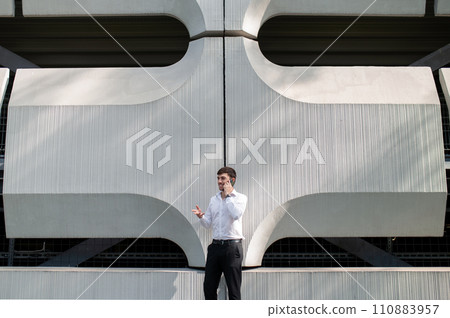 Young man in the city center on a big building background 110883957