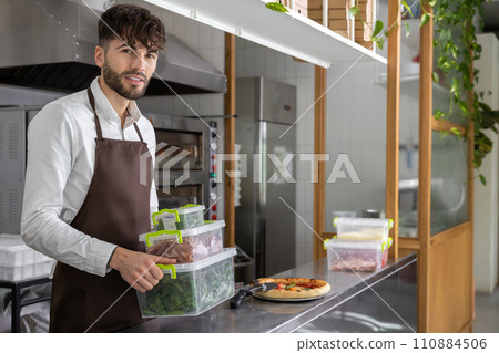 Pizzeria worker with food boxes in hands 110884506