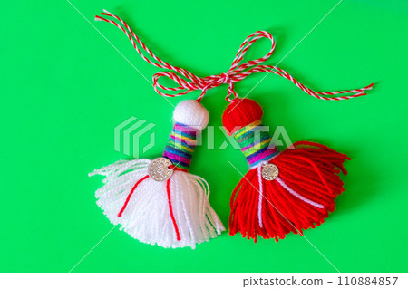 Bulgarian symbol of spring martenitsa on green 110884857
