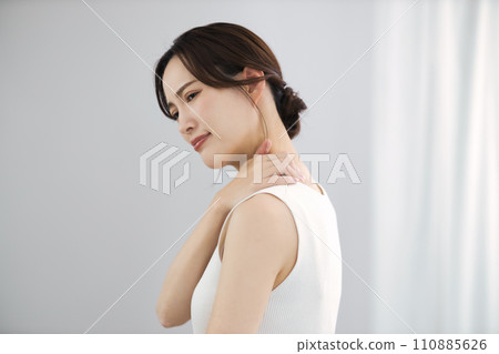 A woman suffering from stiff shoulders A woman suffering from stiff shoulders 110885626
