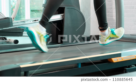 Close up Foot and leg Fitness Asian woman running cool down and stop on treadmill 110885645
