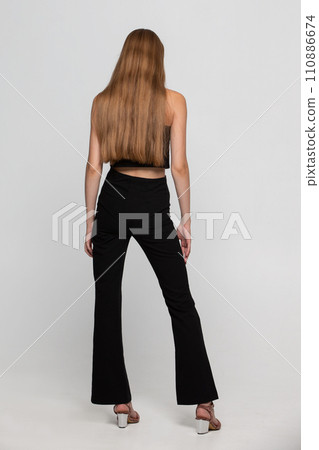 A beautiful girl with beautiful long blond hair turned her back to the camera. A beautiful girl with beautiful long blond hair turned her back to the camera. 110886674